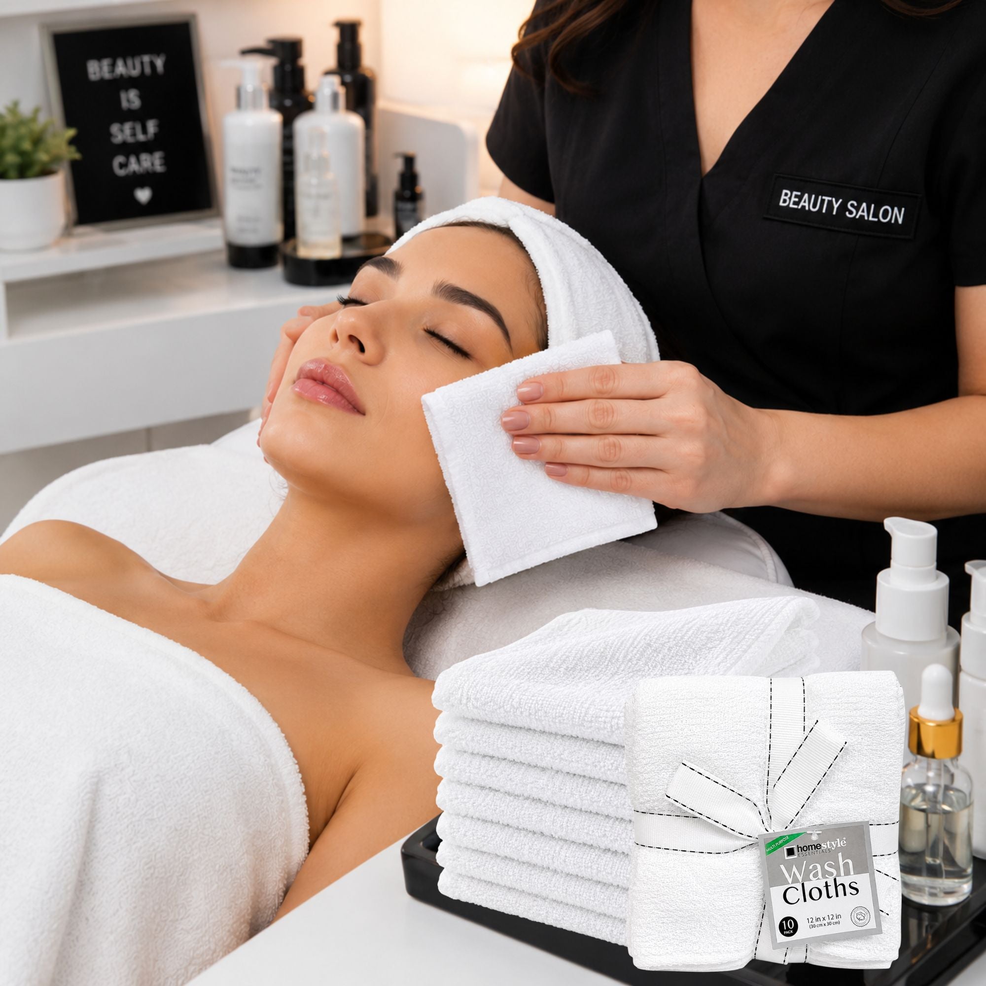 Woman receiving a facial at a beauty salon with towels and skincare products on a counter.