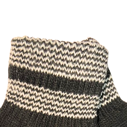 Close-up of a black and beige striped sock on a white background