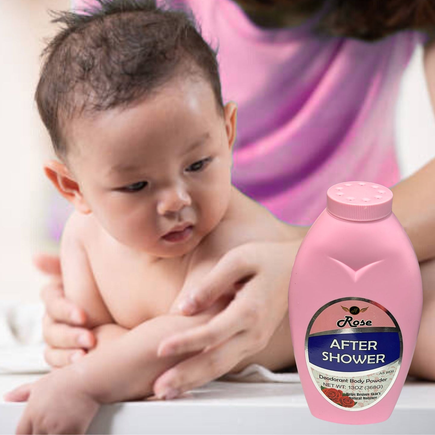 Baby being held by a person with a bottle of 'After Shower' body powder in the foreground.