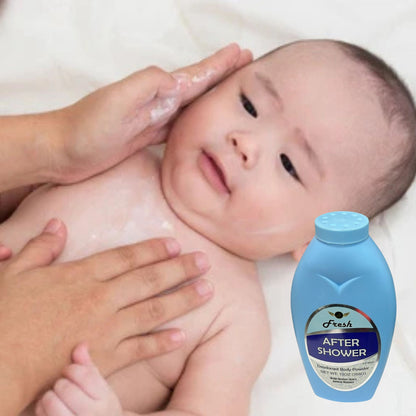 Baby being bathed with a bottle of 'After Shower' product in the foreground