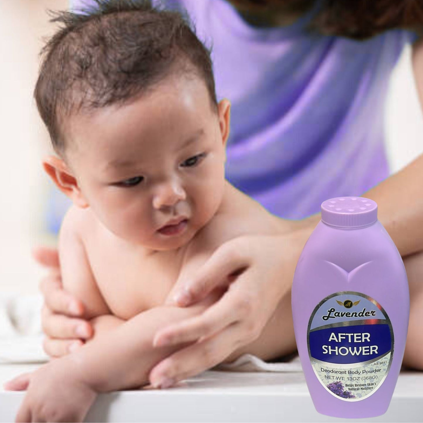 Baby being held by a person with a bottle of 'After Shower' product in the foreground.