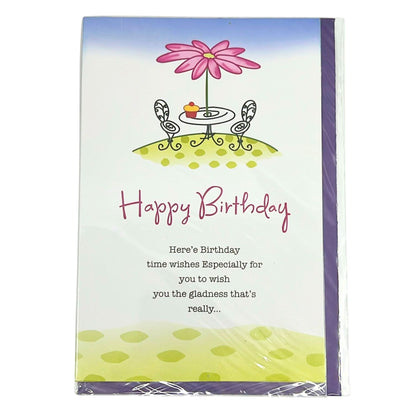 Birthday card with a pink flower, table, and chairs on a white background