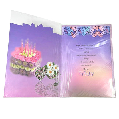 Open birthday card with cake and flowers illustration on a purple background