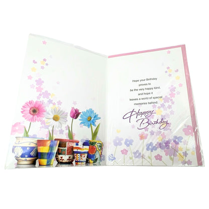 Open birthday card with colorful flowers and decorative text on a white background