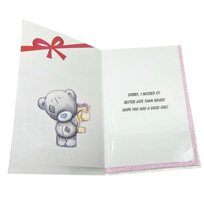 Open card with a teddy bear illustration and text on a white background
