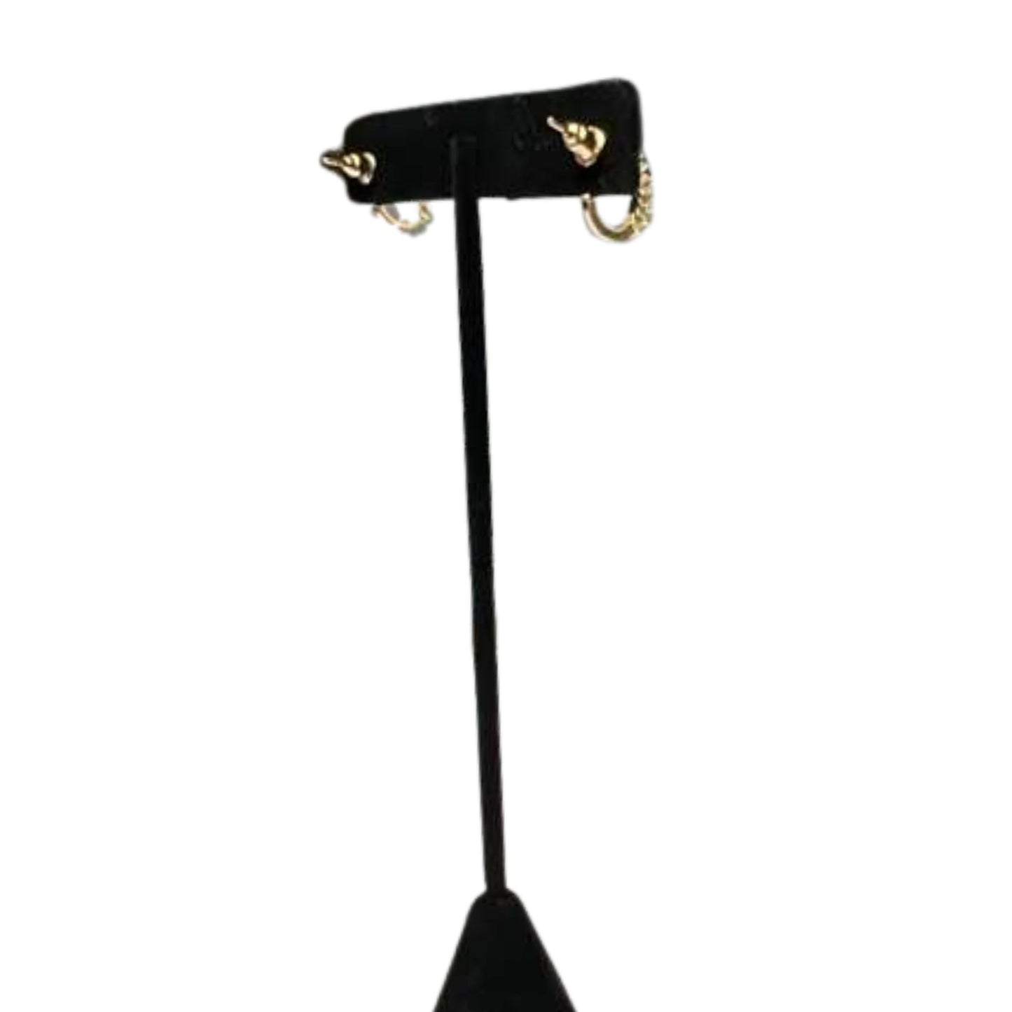 Black earring stand with gold hooks on a white background