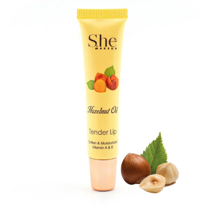 She Makeup Hazelnut Oil Tender Lip balm with hazelnuts and leaves on a white background