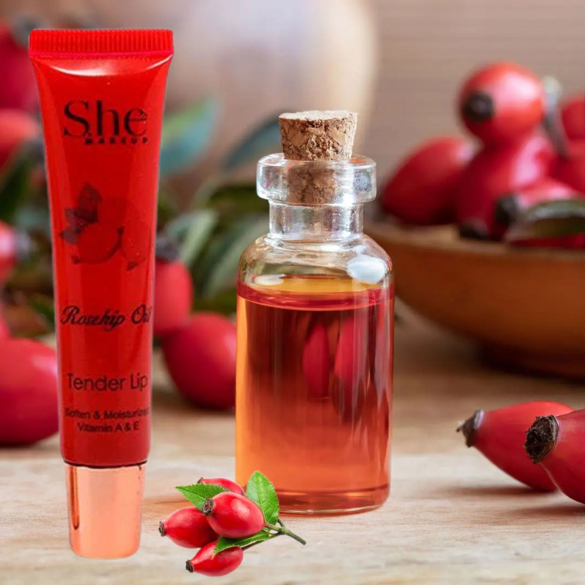 She Rosehip Oil tube and bottle with rosehips on a wooden surface
