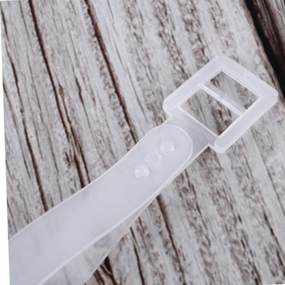 White plastic strap on a wooden surface