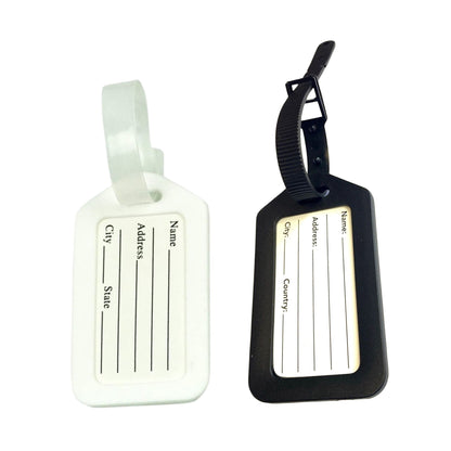 Two luggage tags, one white and one black, with text fields for name, address, city, state, country.