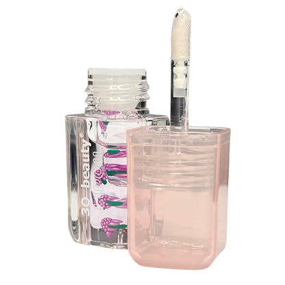 Clear nail polish bottle with pink cap and visible brand label on a white background