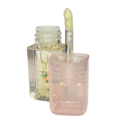 Clear nail polish bottle with a brush on a white background