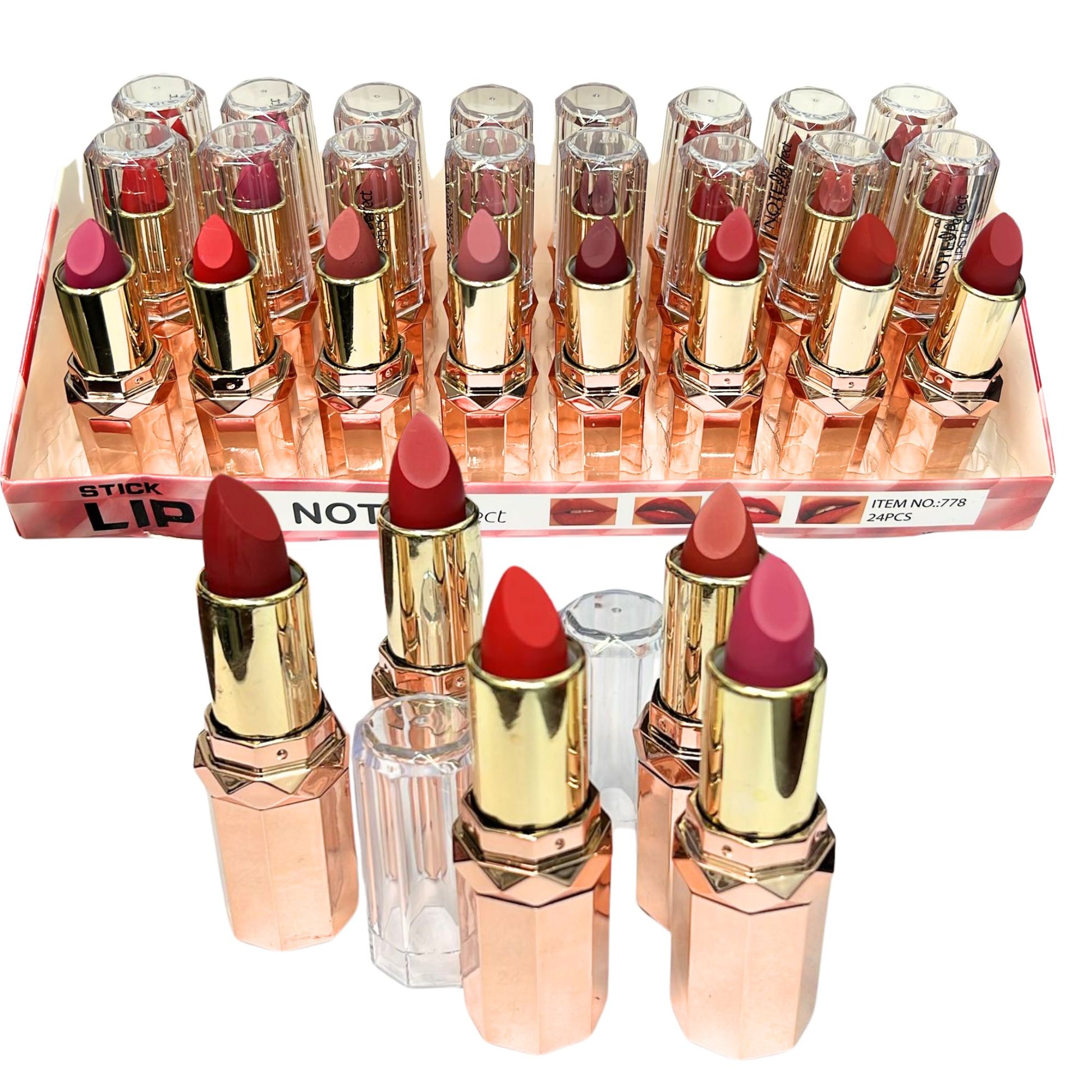 Set of lipsticks with rose gold cases on a white background