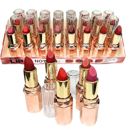 Set of lipsticks with rose gold cases on a white background