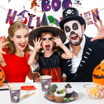 Family celebrating Halloween with decorations and treats on a table.