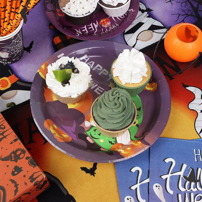Halloween-themed cupcakes on a decorative plate with festive tableware.