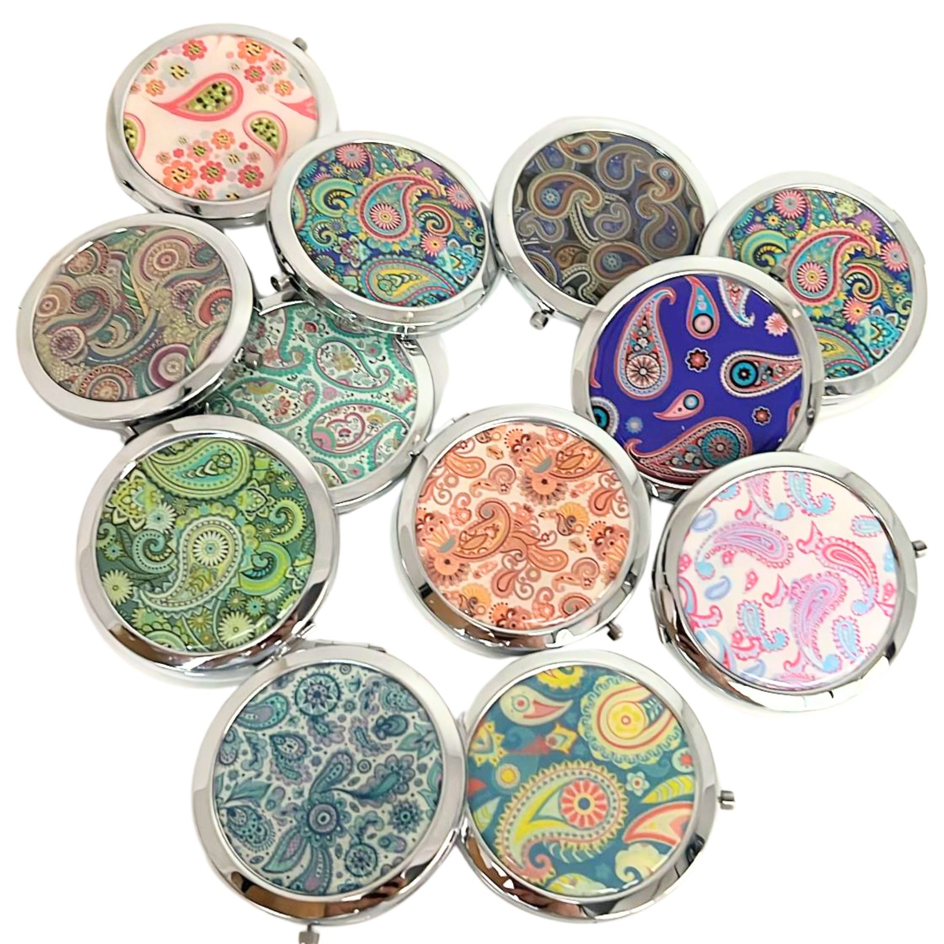 Set of compact mirrors with colorful paisley patterns on a white background