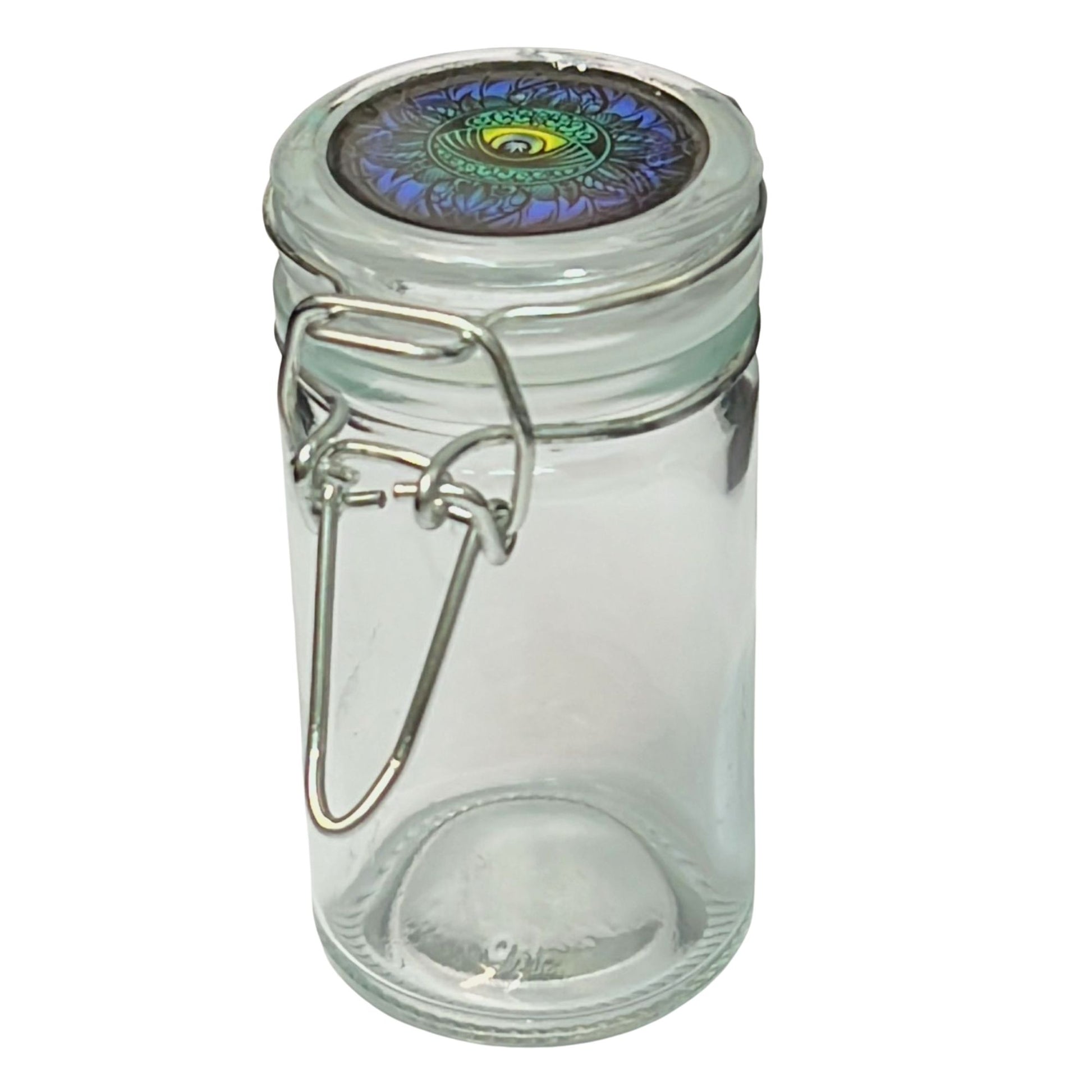 Clear glass jar with a decorative metal lid on a white background