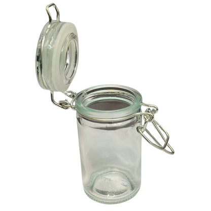 Clear glass jar with a metal clasp on a white background
