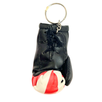 Black leather keychain with a red and white ball on a white background