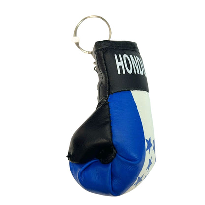 Miniature boxing glove keychain with blue, white, and black design on a white background
