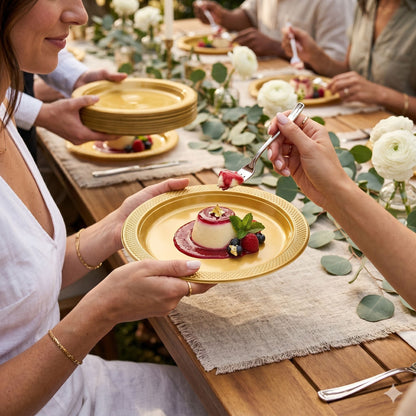gold disposable plastic plates used for dessert at elegant outdoor dining table