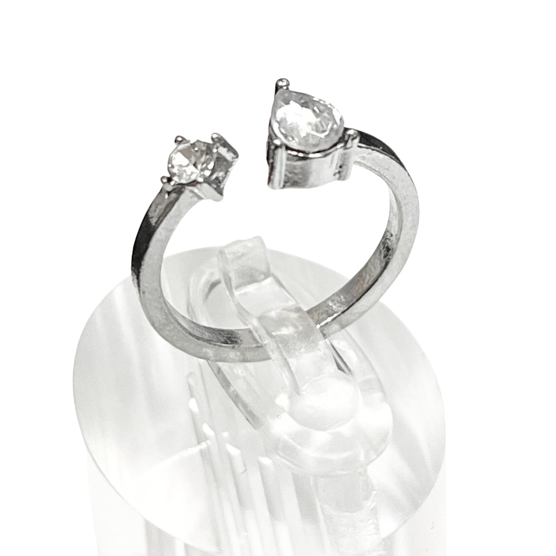 Silver ring with two clear gemstones on a white background