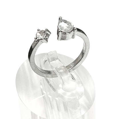 Silver ring with two clear gemstones on a white background