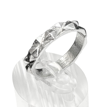 Silver ring with a textured band on a white background