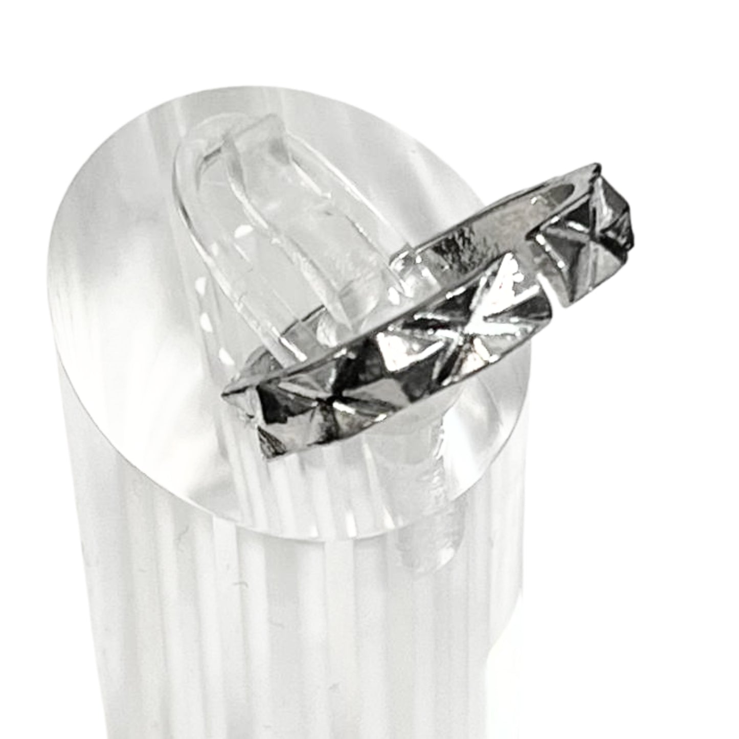 Clear plastic object with a diamond-shaped cutout on a white background