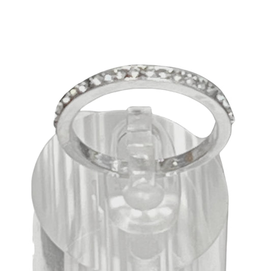 Silver ring with clear gemstones on a white background
