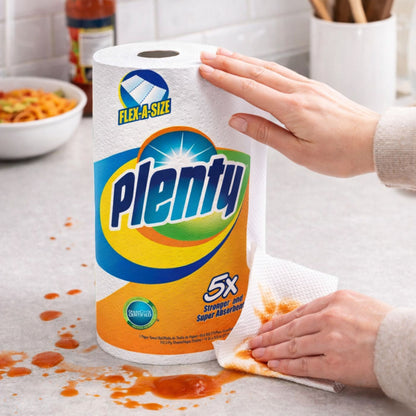 Person using Plenty paper towels to clean a spill on a kitchen counter
