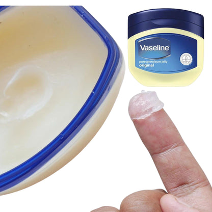 Vaseline jar, open container, and a finger with Vaseline on a white background