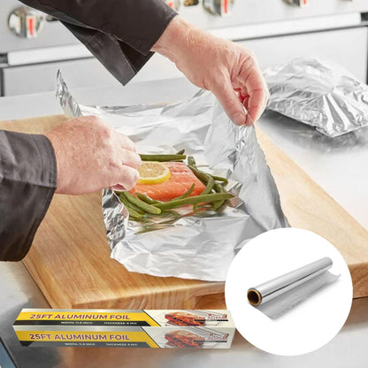 Person preparing food in aluminum foil with a close-up of the foil roll on a kitchen counter.