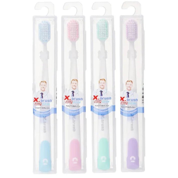 Four X-Brush toothbrushes in pastel colors with packaging on a white background