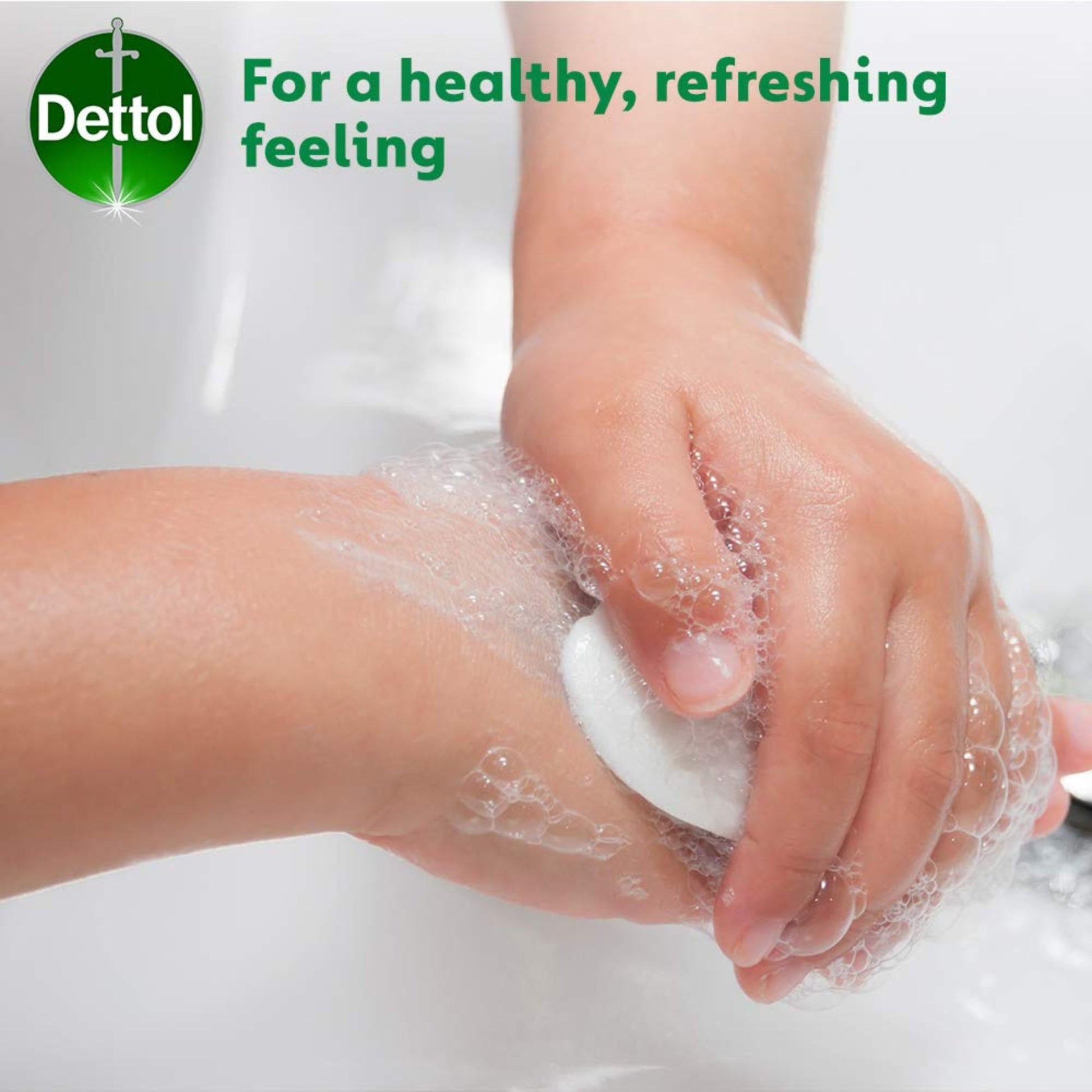 Person washing hands with soap and water, Dettol logo visible